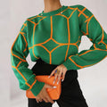 Elegant ladies long sleeve sweater with geometric design.