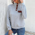 Elegant ladies turtleneck sweater with button details in blue.