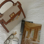 Sola Elegant Handbag with two-tone design and gold-tone hardware. 13